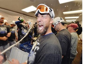 Alex Gordon #4 of the Kansas City Royals celebrates in the locker room with his teammates after the defeating the Chicago White Sox to clinch a wildcard spot in the playoffs at U.S. Cellular Field on September 26, 2014 in Chicago, Illinois. The Royals defeated the White Sox 3-1.