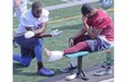 Alouettes cornerback Geoff Tisdale, right, holds back his pain, while applying ice to his ankle, while S.J. Green looks on. Tisdale hurt his ankle during Alouettes practice on Thursday Sept. 04, 2014.