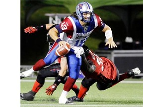 Alouettes quarterback Johnathan Crompton avoids a sack by Redblacks’ Jonathan Williamsduring Als’ win in Ottawa Friday night. Fred Chartrand/ THE CANADIAN PRESS