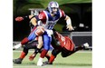 Alouettes quarterback Johnathan Crompton avoids a sack by Redblacks’ Jonathan Williamsduring Als’ win in Ottawa Friday night. Fred Chartrand/ THE CANADIAN PRESS