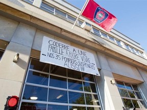 A banner hanging outside a fire station in Ville St-Laurent, Montreal, Thursday, September 25, 2014. The banner is similar to others at fire stations around the city. The banner denounces the suspension of 35 firefighters following a rowdy protest at Montreal city hall.