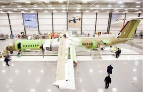 Bombardier Aerospace employees assemble a Q400 airliner at the Bombardier aircraft manufacturing facility in Toronto.