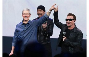 U2’s Bono, right, and the Edge, centre, rock out with Apple CEO Tim Cook at the company’s product launch on Sept. 9, which doubled as the launch for the Irish group’s new album, Songs of Innocence. Juan Rodriguez says U2 and Apple’s association is representative of that old trick: aligning a product with power, and vice versa.
