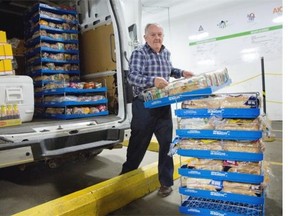 Brian Cadoret loads his van with bread at Moisson Montreal. He works with  the St. Vincent de Paul Society of the Parish of the Resurrection of Our Lord, in Lachine.