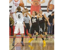Brothers Will, centre, and Win Butler, right,  of Arcade Fire participate in a Pop vs Jock basketball game took place at the McGill University Sports Centre in Montreal, Saturday September 20, 2014, as part if the Pop Montreal Festival. The Pop team consisted of Arcade Fire's Win and Will Butler, as well as Bon Iverís Justin Vernon, Strokes bassist Nikolai Fraiture, Kid Koala,and others. Proceeds for the event will go to DJ Sports Club, a Montreal non-profit charity that provides sports and education programs to young Montrealers .