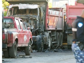 One of two burnt trucks at Le Pavage Royal City Inc. construction company at 8205 du Creusot St. in St-Léonard on Friday, Sept. 19, 2014.  The Montreal police arson unit is investigating.