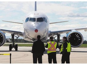 Bombardier's CS100 plane taxis in after its maiden test flight at the company's facility on Sept. 16, 2013, at Mirabel airport.