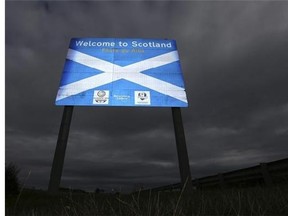 A sign welcoming motorists to Scotland at Berwick Upon Tweed, England, Monday, Sept. 8, 2014. The British government plans to offer Scotland more financial autonomy in the coming days as polls predict a very close vote in the September 18 on Scottish independence. (AP Photo/Scott Heppell)