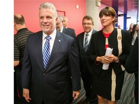 Quebec Premier Philippe Couillard, left, and Gaz Metro chief executive Sophie Brochu arrive at a news conference Tuesday, September 30, 2014 in Montreal. Gaz Metro and the Quebec government announced a partnership to increase the natural gas liquefaction capacity at the Gaz Metro plant in eastern Montreal. THE CANADIAN PRESS/Ryan Remiorz ORG XMIT: RYR101