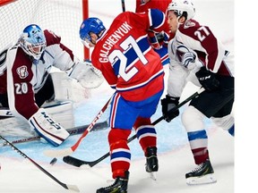 Canadiens’s Alex Galchenyuk is stopped by Avalanche goalie Reto Berra as Bruno Gervais moves in during their preseason game Thursday at the Bell Centre. Galchenyuk was used at centre during the first week of training camp, but has now been moved to the wing.