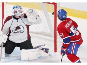 Canadiens’ David Desharnais and Avalanche goalie Reto Berra watch as a shot by Habs’ Max Pacioretty finds the back of the net during preseason action at the Bell Centre on Thursday night.