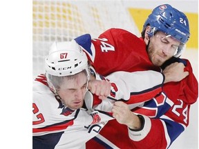 Canadiens’ Jarred Tinordi, right, lands a right to the head of Capitals’ Chris Brown during a third period fight in Montreal on Sunday, September 28, 2014.