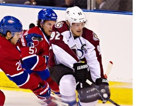 Canadiens’ Nathan Beaulieu and David Desharnais battle for the puck against Avalanche’s Gabriel Landeskog during the first period on Friday night at Le Colisée in Quebec City. Clément Allard/THE CANADIAN PRESS