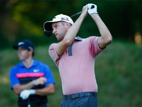 Chris Kirk tees off on the 15th hole playing with world No. 1 Rory McIlroy, background, during the final round of the Deutsche Bank Championship at the TPC Boston on Monday in Norton, Mass.