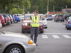 Traffic circulation officer Claire Frechette directs traffic with an iron fist.
