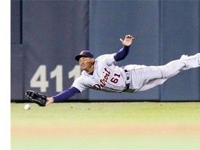 Detroit Tigers centre-fielder Ezequiel Carrera makes a futile attempt for a grounder as Minnesota Twins’ Kurt Suzuki doubles to send in the tying run in the ninth inning on Sept. 16, 2014, in Minneapolis. The Twins won 4-3 with a single by Aaron Hicks.