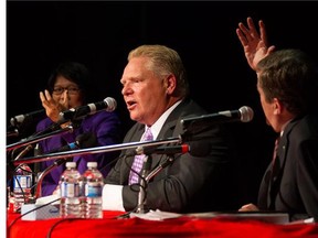 Doug Ford, centre, is pushed to answer a question as whether he will march in annual Pride parade by fellow candidates John Tory, right, and Olivia Chow as he takes part in a Toronto Mayoral Debate in Toronto on Tuesday, September 23, 2014. THE CANADIAN PRESS/Chris Young