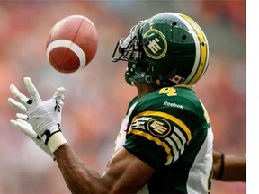 Edmonton Eskimos’ Adarius Bowman catches a pass for a touchdown against the B.C. Lions in Vancouver on Saturday, June 28, 2014.