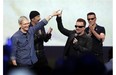 Apple CEO Tim Cook, left, greets Bono from the band U2 after they preformed at the end of the Apple event on Tuesday, Sept. 9, 2014, in Cupertino, Calif. Apple unveiled a new Apple Watch, the iPhone 6 and Apple Pay. (AP Photo/Marcio Jose Sanchez)