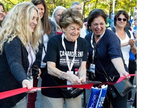 Evelyn Farha, honorary president of the Farha Foundation cuts a ribbon prior to the Ça Marche walkathon to raise money and awareness for AIDS, in Montreal, Saturday Sept. 27, 2014.