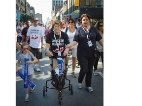 Evelyn Farha, honorary president of the Farha Foundation takes part in the Ça Marche walkathon to raise money and awareness for AIDS, in Montreal, Saturday Sept. 27, 2014.