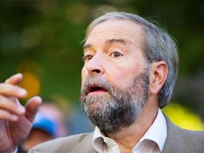 Federal NDP leader Thomas Mulcair announces at a news conference in front of the Vancouver Art Gallery in Vancouver, B.C., on Saturday, September 13, 2014 that the NDP would bring back the minimum wage for federal employees if they form the next government.