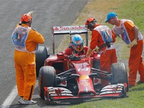 Ferrari driver Fernando Alonso of Spain leaves his car after failing to complete the race during the Italian Formula One Grand Prix in Monza on Sunday.