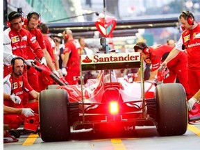 Ferrari driver Fernando Alonso of Spain steers his car into the pit lane during the first practice session for the Singapore Formula One Grand Prix on Friday.