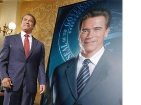 Former California Governor Arnold Schwarzenegger with his official portrait after it was unveiled at the Capitol in Sacramento on Monday. He sat for the portrait with an image of wife Maria Shriver on his lapel, which has since been edited out.