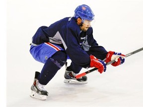 Francis Bouillon squats into a stretch during practice at their Brossard training facility on Wednesday, April 30. He will be among the 64 players who will be on hand as the Canadiens open training camp Thursday morning in Brossard.