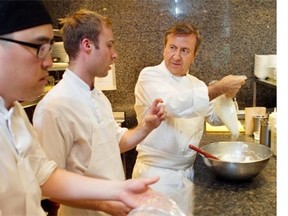 French-born New York chef Daniel Boulud (right) in the kitchen of Maison Boulud on Wednesday, August 20, 2014 at the Ritz Carlton with cook Ilhwan Chee (left) and sous-chef Antoine Baillargeon. Chef Boulud runs restaurants around the world. (John Kenney / THE GAZETTE)