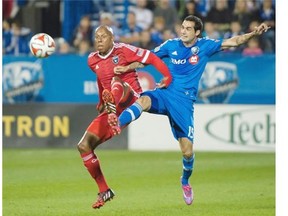 Impact’s Andres Romero, right, and San Jose Earthquakes’ Jordan Stewart battle for the ball during first half MLS soccer action in Montreal on Saturday.