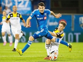 Impact’s Ignacio Piatti, left, and Columbus Crew’s Wil Trapp battle for the ball during the second half at Saputo Stadium on Saturday.