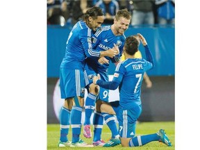Impact’s Jack McInerney, centre, celebrates with teammates Issey Nakajima-Farran, left, and Felipe Martins after scoring against the San Jose Earthquakes during second half MLS soccer action in Montreal on Saturday.