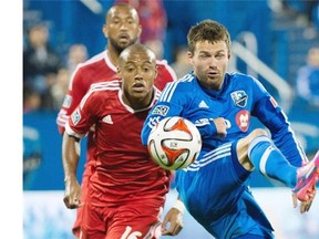 Impact’s Jack McInerney, right, and San Jose Earthquakes’ Pablo Pintos battle for the ball during second half MLS soccer action in Montreal on Saturday.