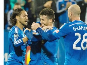 Impact players Issey Nakajima-Farran, left to right, Jack McInerney, Felipe Martins and Jeremy Gagnon-Lapare celebrate a goal by McInerney against the San Jose Earthquakes during second half MLS soccer action in Montreal on Saturday.