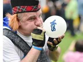 A pro-independence supporter blows a “Yes” balloon during a rally in multicultural Glasgow on Sept. 17, a day ahead of the referendum on Scotland’s independence. The No won by a 55-45 margin, but it Yes won 58 per cent of hte vote in Glasgow.