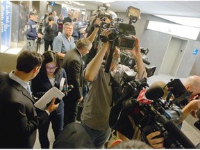 Journalists wait outside a courtroom at the Montreal courthouse, Monday, September 29, 2014, during the start of the murder trial for Luka Magnotta.