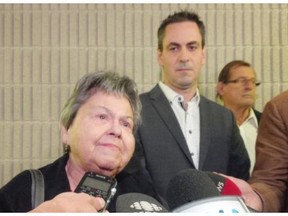 Lise Blais and her son, Martin, speak to reporters during proceedings Monday, September 22, 2014 at the Montreal courthouse. Blais is the wife of the designated plaintiff in a class-action lawsuit against big tobacco in Montreal. The plaintiff, Jean-Yves Blais, died in 2012.