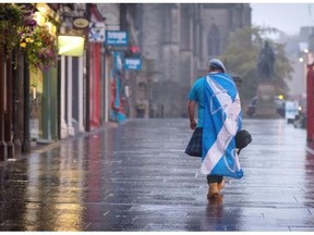 A lone YES campaign supporter walks down a street in Edinburgh after the result of the Scottish independence referendum, Scotland, Sept. 19, 2014. Quebecers definitely hold a more exciting referendum.