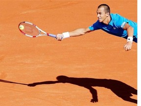 Lukas Rosol of the Czech Republic returns the ball against France's Jo-Wilfried Tsonga during their single match in the semifinal of the Davis Cup at the Roland Garros stadium, in Paris, Friday, Sept. 12, 2014.