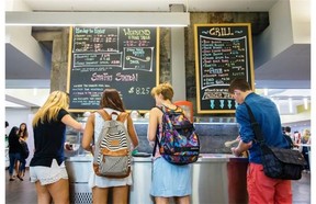 McGill students choose items from the stir fry station at the dining hall of the Royal Victoria College residence.