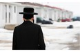 A member of the Lev Tahor ultra-orthodox Jewish sect walks home from taking his son to school in Chatham, Ont., Monday, March 10, 2014.