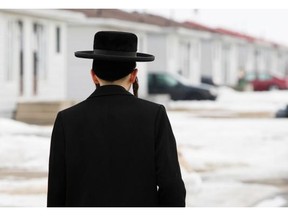 A member of the Lev Tahor ultra-orthodox Jewish sect walks home from taking his son to school in Chatham, Ont., Monday, March 10, 2014.