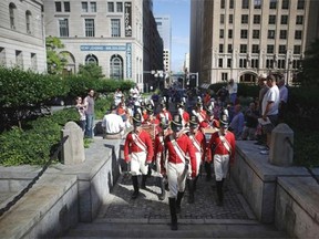 Members of the The Fort McHenry Guard Field Musicians perform at the base of the Battle Monument during the Star Spangled Spectacular September 12, 2014 in Baltimore, Maryland. Celebrating the 200th anniversary of the United States' national anthem whose lyrics come from 'Defence of Fort M'Henry,' a poem written in 1814 by Francis Scott Key after he witnessed the bombardment of Fort McHenry by British ships during the War of 1812.