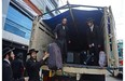 Members of an ultra-Orthodox Lev Tahor Jewish group unload their belongings from a truck as they arrive at the building where they will remain in Guatemala City on September 2, 2014. 230 ultra-Orthodox Lev Tahor Jews were expelled from the town of San Juan La Laguna by Mayan indigenous leaders.
