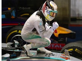 Mercedes driver Lewis Hamilton of Britain celebrates after winning the Formula One Singapore Grand Prix at the Marina Bay street circuit on September 21, 2014.