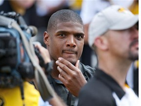 Former Missouri player Michael Sam watches pregame festivities before the start of the South Dakota State-Missouri NCAA college football game Saturday in Columbia, Mo. Sam, the first openly gay player drafted by an NFL team, has cleared waivers. Sam was released by the Rams on Saturday. (L.G. Patterson/The Associated Press)