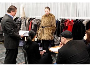 A model wears a coat for buyers at the Natural Furs Global Furs booth at StyleLab Montreal trade show in Montreal on Sunday March 16, 2014.