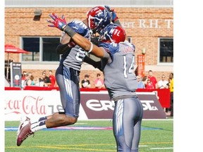 Montreal Alouettes; Chad Johnson, left, celebrates catching a pass with team-mate Brandon London during second half of Canadian Football League game against the Hamilton Tiger Cats in Montreal Sunday, Sept. 7, 2014.